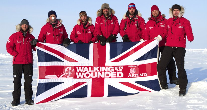 WWTW team at the North Pole holding a flag