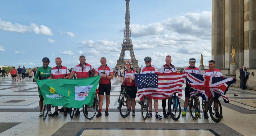 A team from Sunbelt rentals on a cycling event in front of the Eiffel Tower in Paris