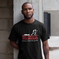 A man modelling a black T-shirt with the WWTW logo on it