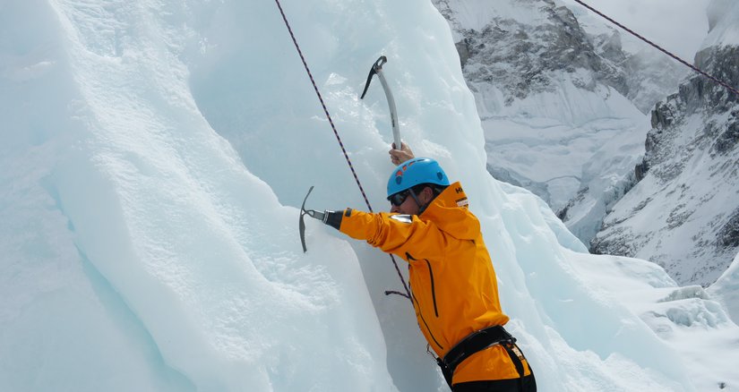 A person climbing Everest with an ice pick