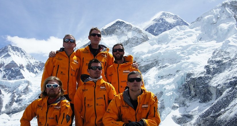 The team climbing Everest with the mountains behind them