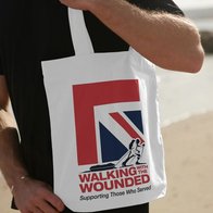 Someone carrying a WWTW branded tote bag with a graphic Union Jack design